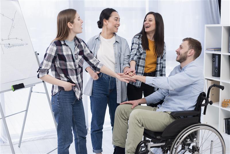 Coworkers in meeting with wheelchair user